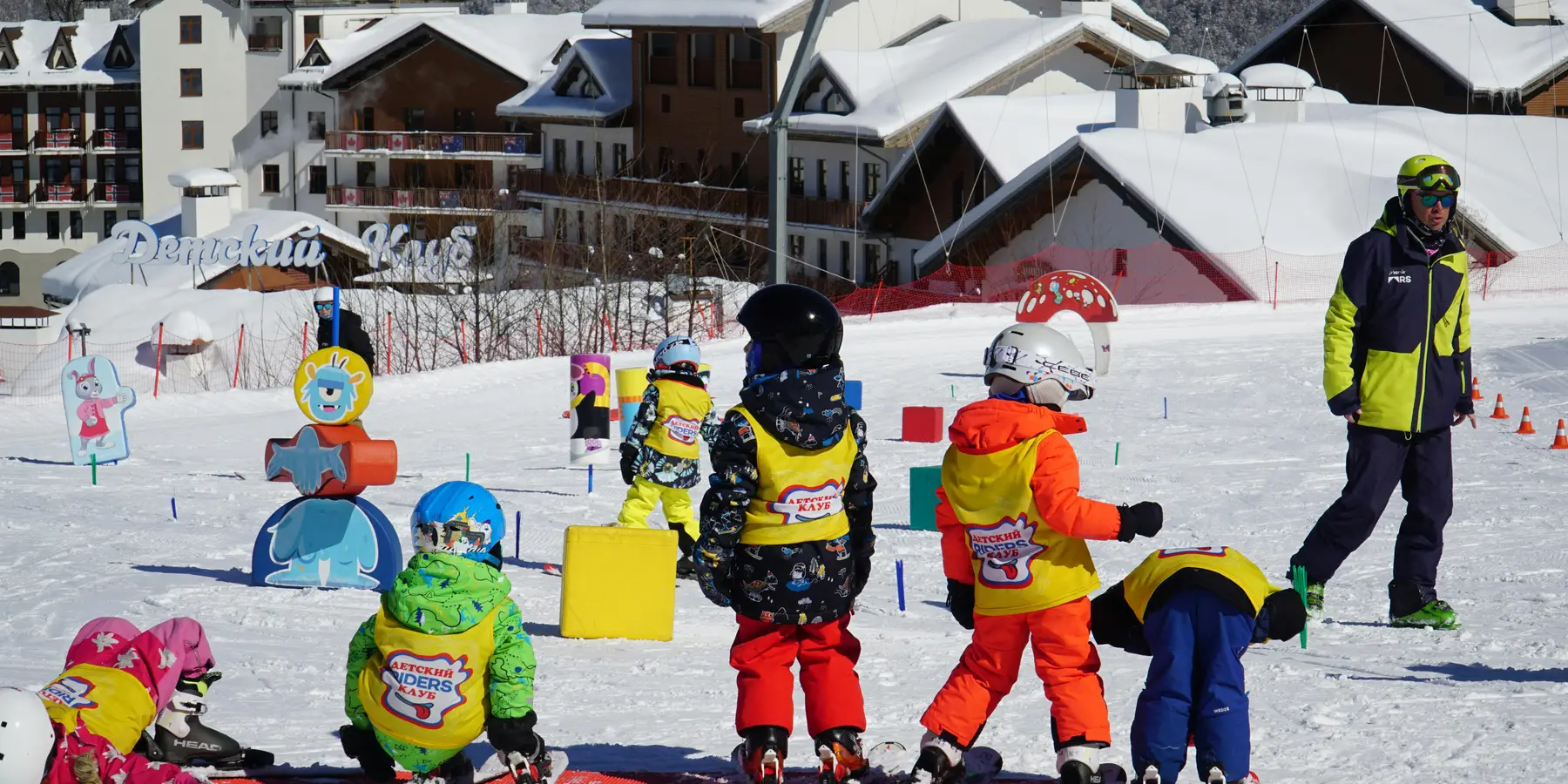 Children learning to ski in a kids snow school area